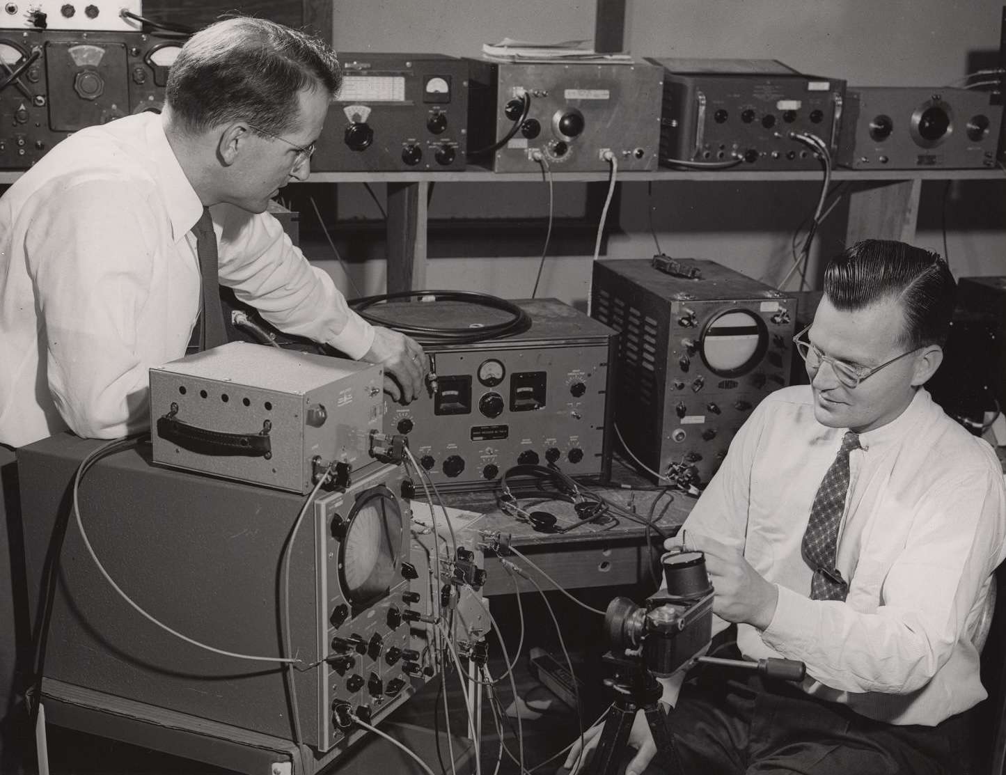 Two men in a lab with large machinery