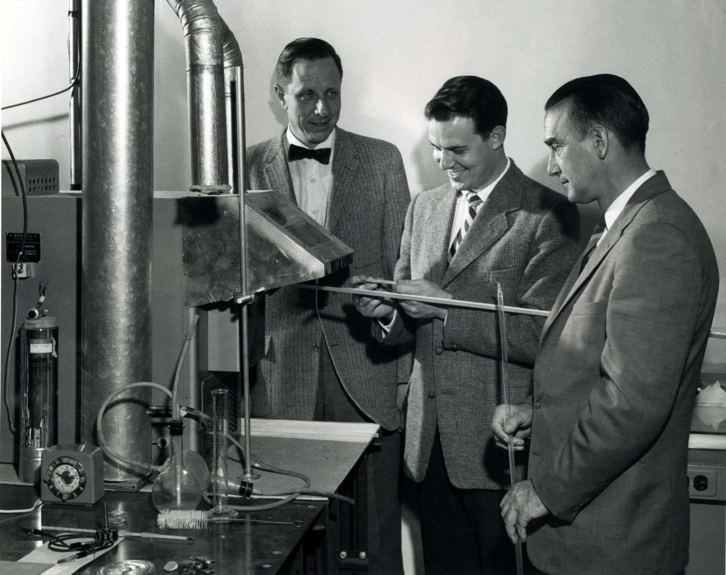 A group of people standing in front of a nuclear reactor