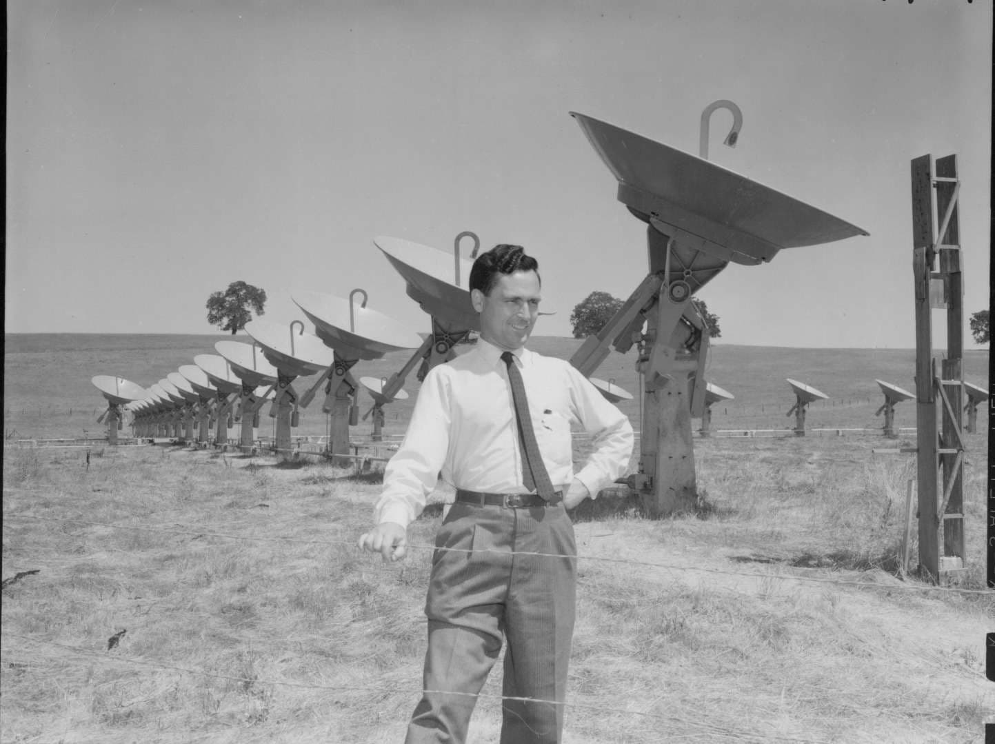 Ronald Bracewell standing in front of a radio telescope