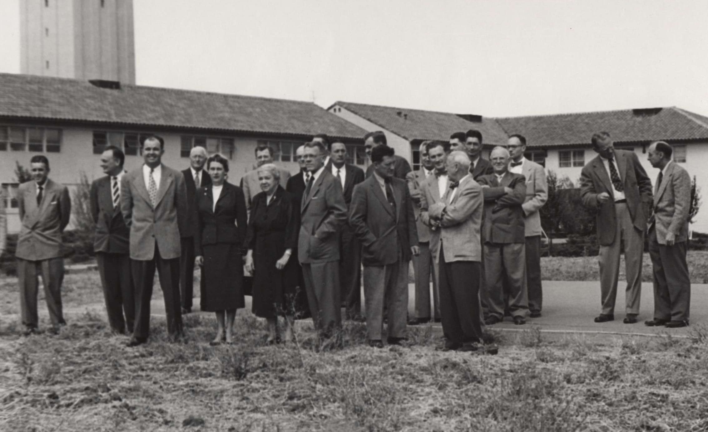 A group of engineering faculty members standing in front of a building