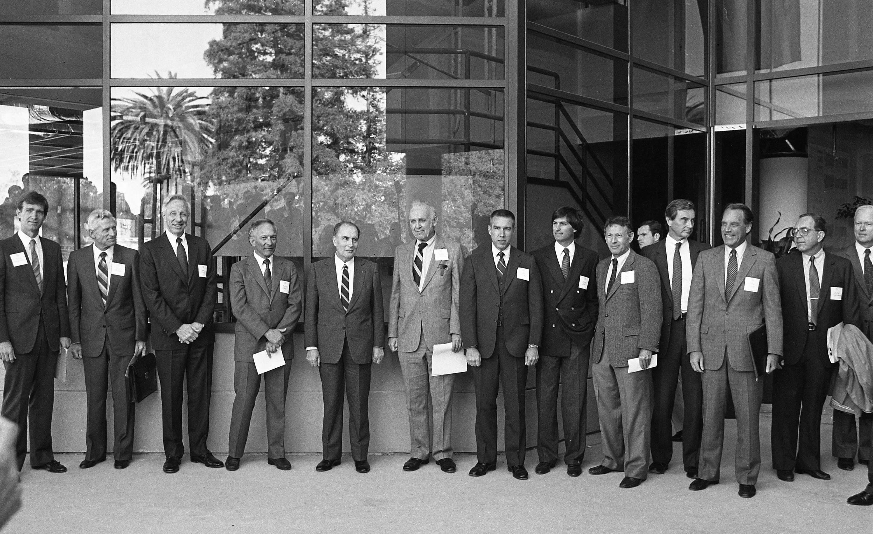 A group of men in suits standing together outside.