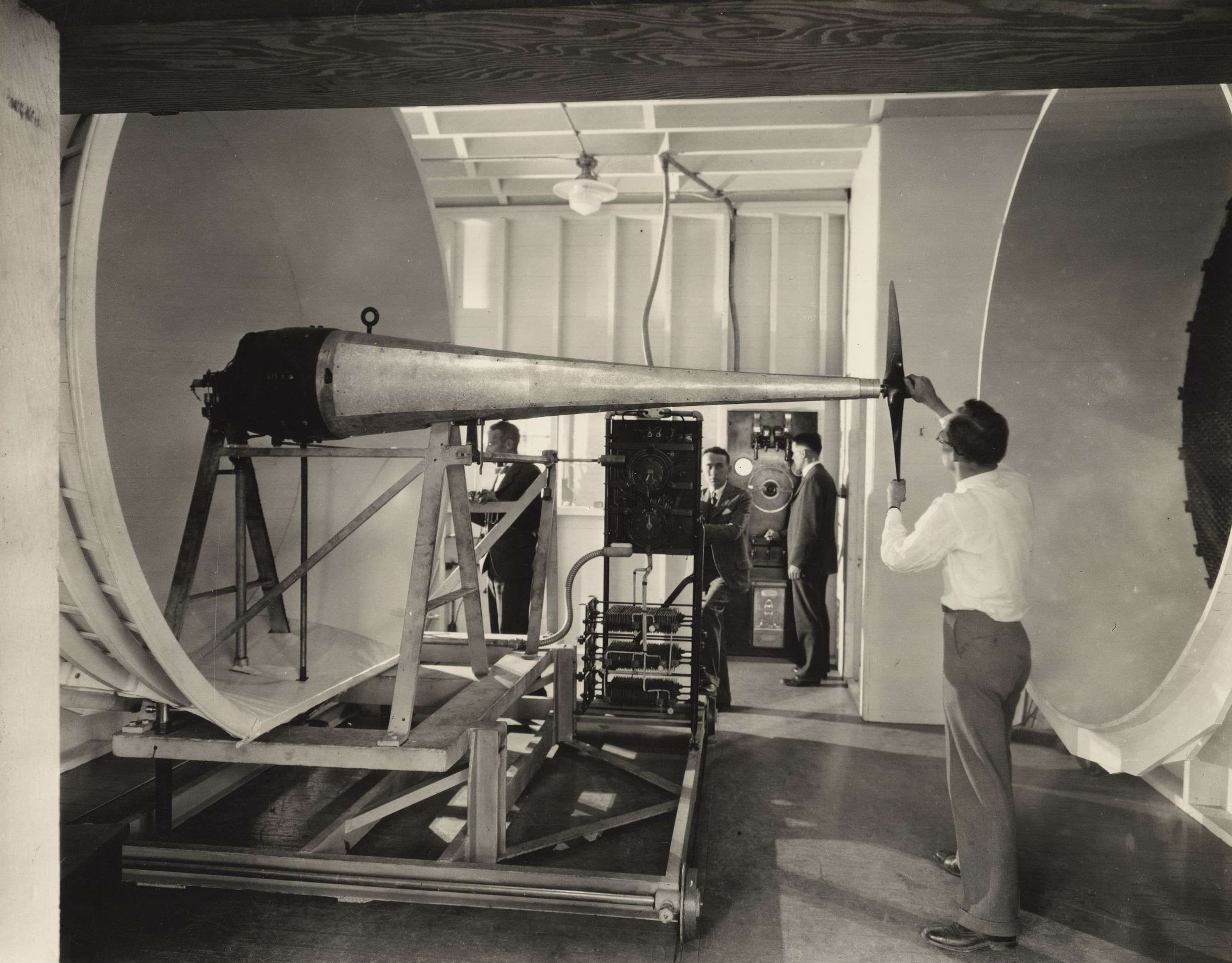 Interior of the Guggenheim Aeronautics Laboratory, depicting a man alongside a large machine
