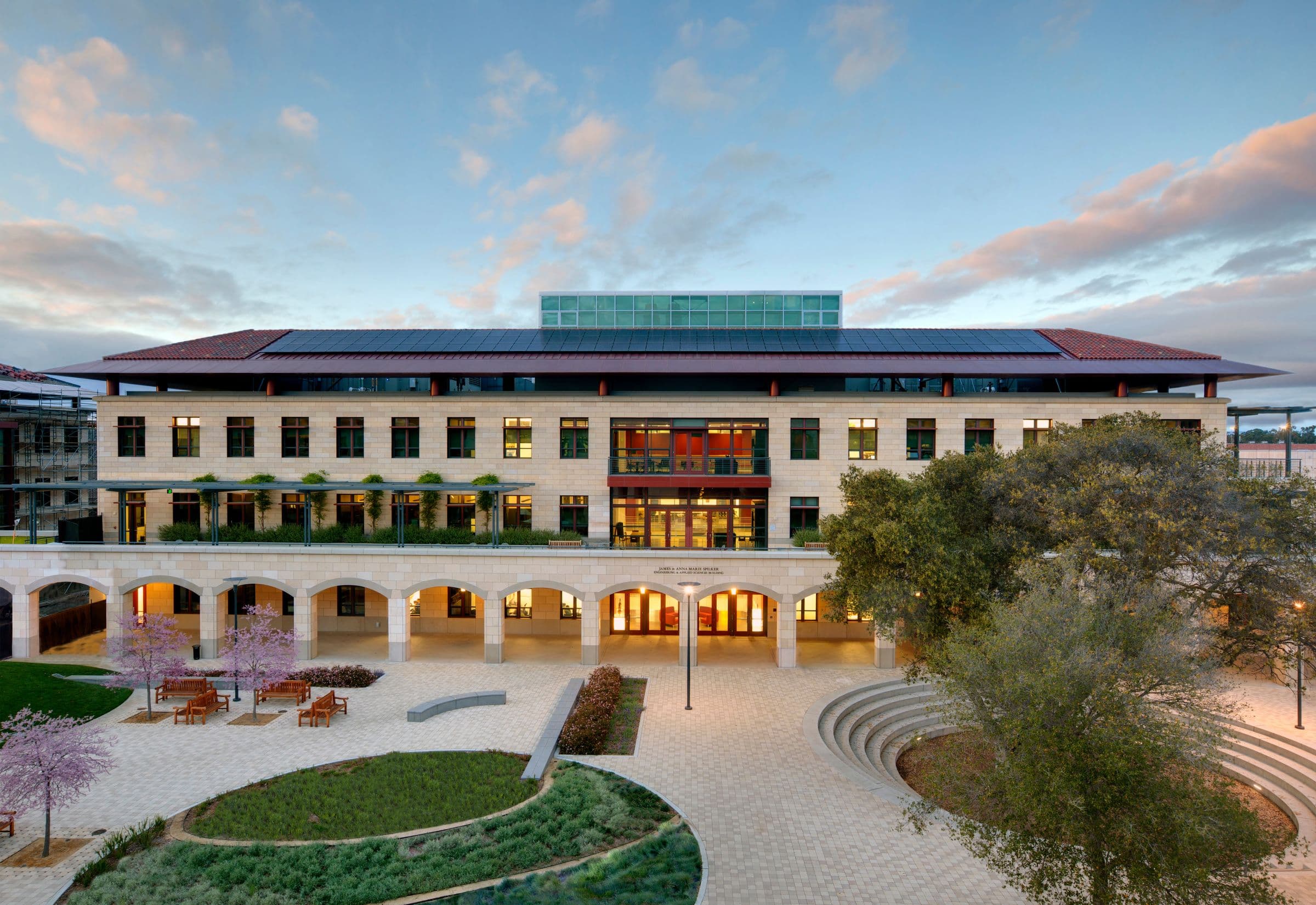 An exterior view of the James and Anna Marie Spilker Engineering and Applied Science Building on Stanford University campus, showcasing its gorgeous architecture with a vibriant blue sky.